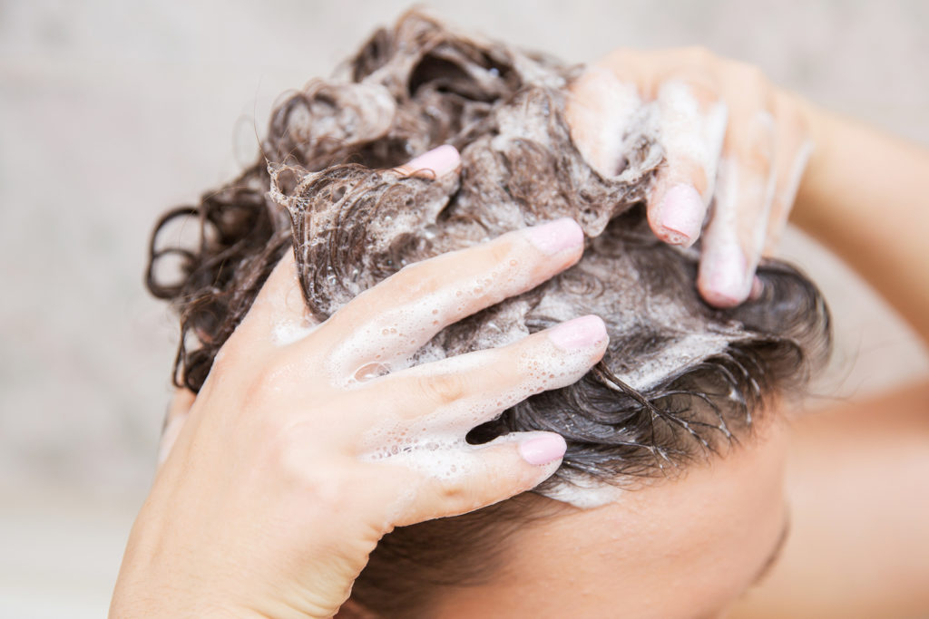 young woman washing her hair