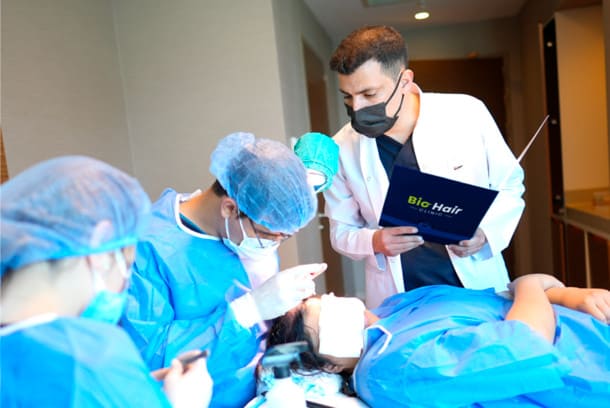 Dr Ibrahim monitoring his team doing the DHI Hair Transplant