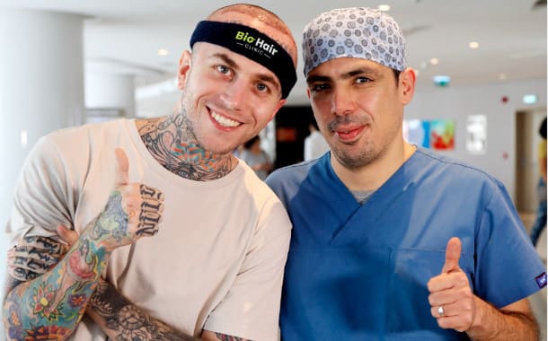 Smiling patient with doctor Ibrahim after a hair transplant