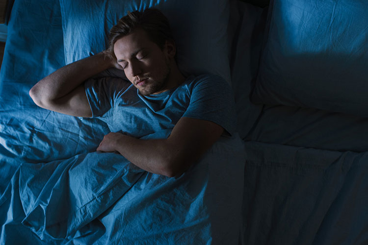 Ein Mann liegt schlafend in einem Bett